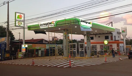 Estación de servicio Integral iluminada al atardecer